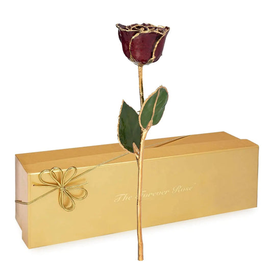 A 24K gold-dipped rose with garnet sparkle finish, presented in a golden box with a ribbon.