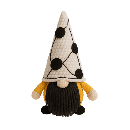 A handcrafted crochet gnome with a tall white hat with black dots, a mustard yellow body, and a black beard