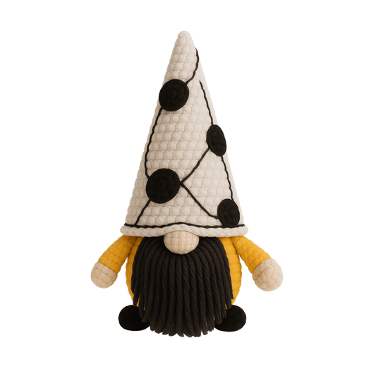 A handcrafted crochet gnome with a tall white hat with black dots, a mustard yellow body, and a black beard