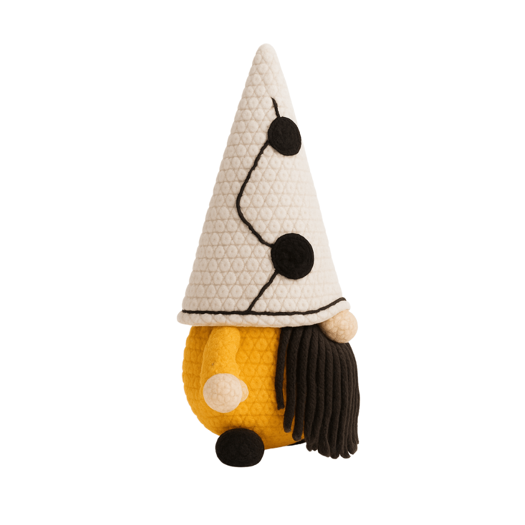 A handcrafted crochet gnome with a tall white hat with black dots, a mustard yellow body, and a black beard