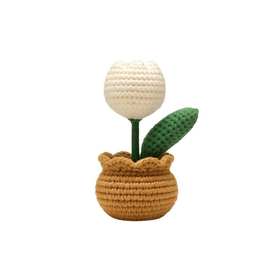 Crocheted potted plant with a white flower and green leaves