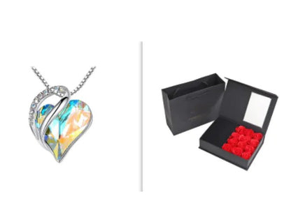 A set of a heart-shaped pendant necklace with an Aurora crystal pendant surrounded by smaller clear crystal and a box.