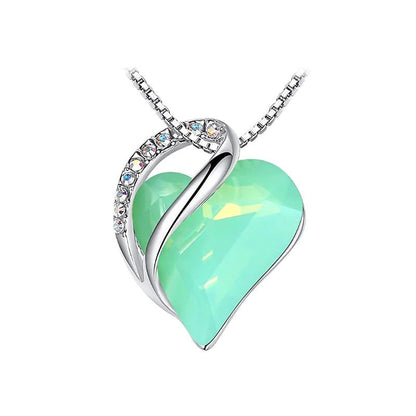 A heart-shaped pendant necklace with a Mint crystal pendant surrounded by smaller clear crystal.