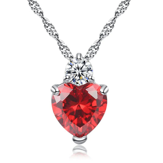 A heart-shaped zircon necklace with a white copper chain, featuring a prominent red zircon crystal