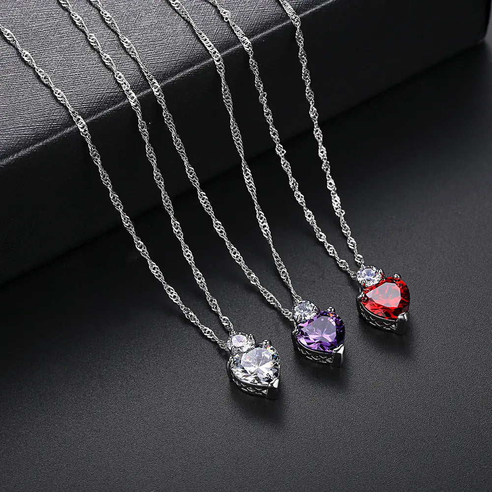 Three heart-shaped zircon necklaces with a white copper chain