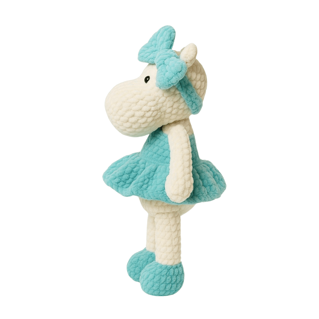 Handmade crochet doll in the shape of a hippopotamus wearing a teal dress and matching bow headband