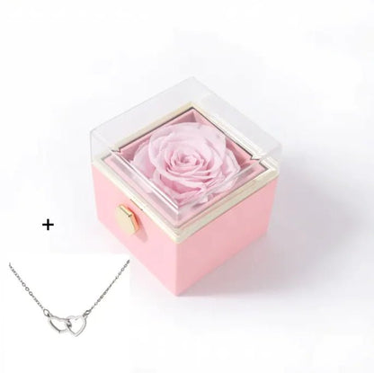 Pink rose in a box with a silver necklace 
