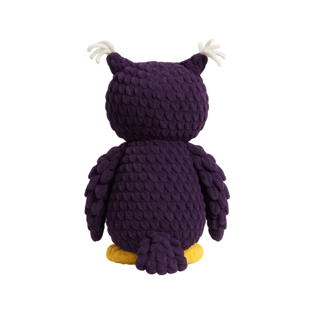Handmade crochet plush owl with deep purple feathers, pink chest, and gold feet, with a peaceful closed-eye expression