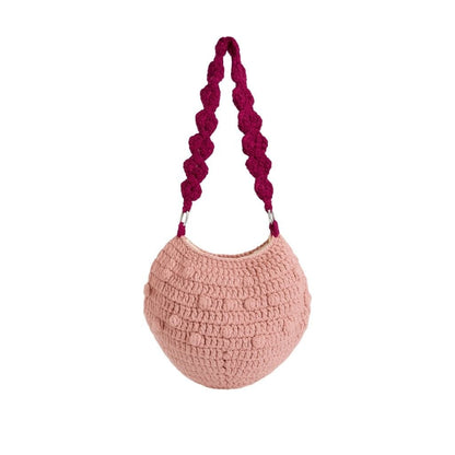 Pink handbag with a purple handle and cherry decoration