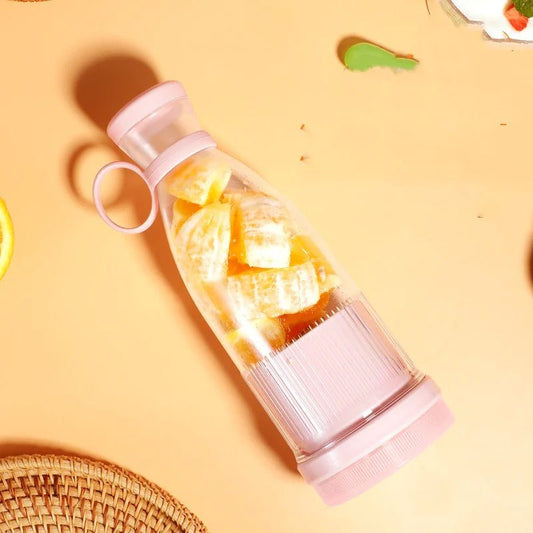A portable USB blender bottle with pieces of fruit inside.